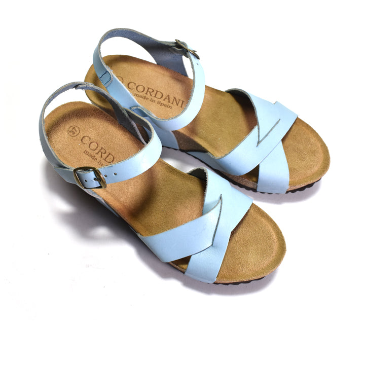 Pair of light blue sandals with cork sole on a white background