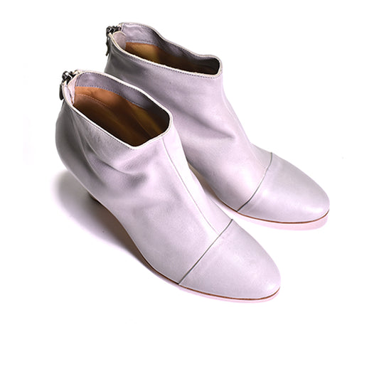 pair of white heeled boots