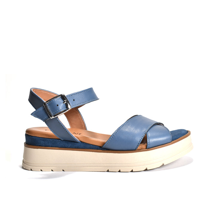 Blue sandal with a white sole on a white background