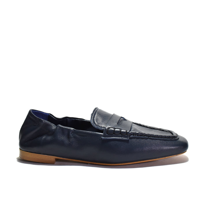 Blue loafer with embellishments on a white background