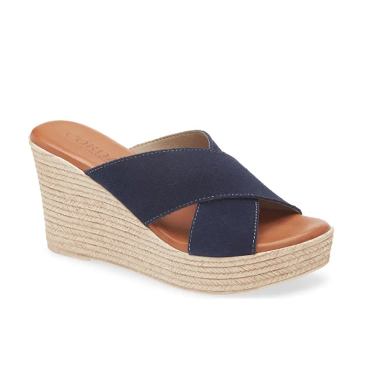 Navy wedge sandal with tan sole on a white background