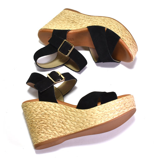 Woven-look wedge sandals with black straps on a white background