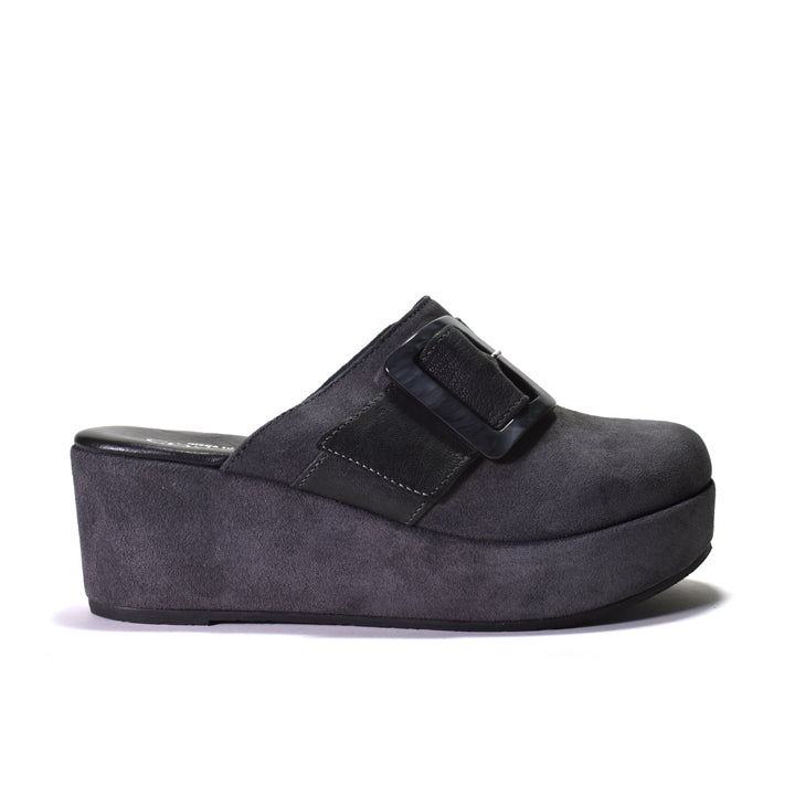 A dark gray suede platform mule shoe with a wide grey leather strap and a large decorative buckle, shown from a side profile on a white background.