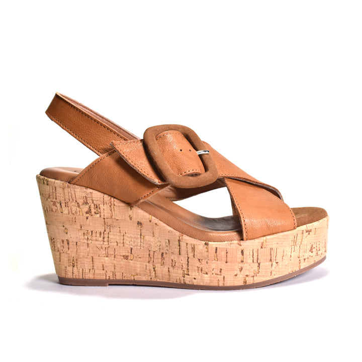 Brown wedge sandal with cork sole on a white background