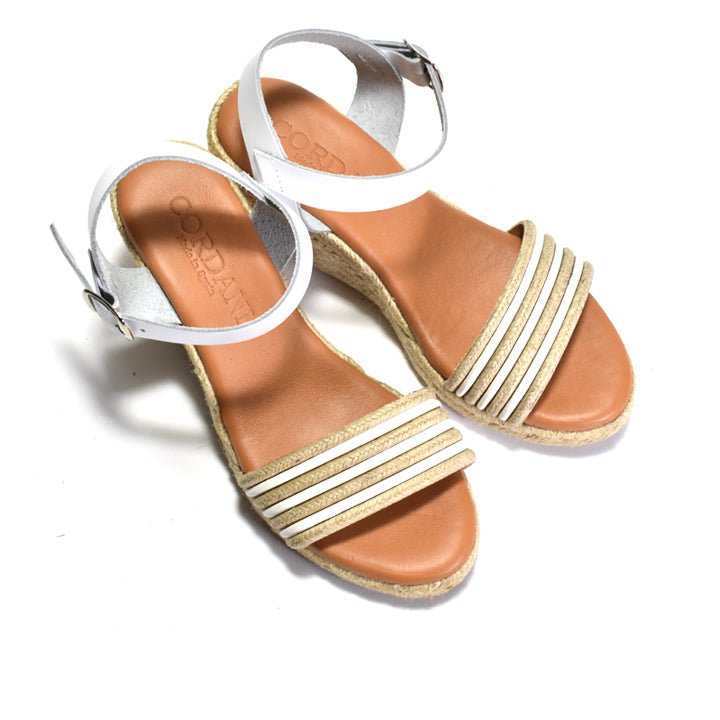pair of sandals sandal with espadrille sole on a white background