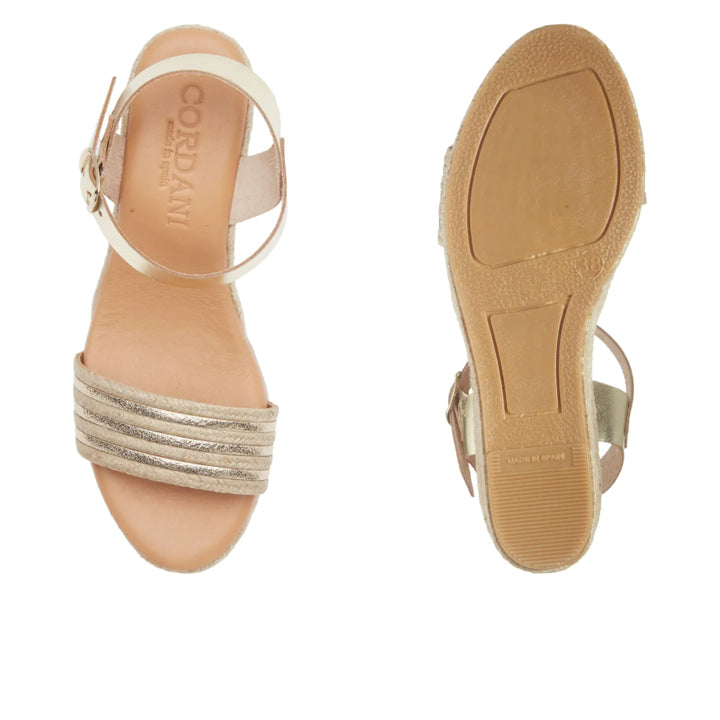 Beige sandal with metallic straps on a white background