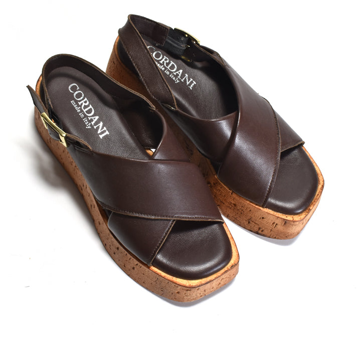 Pair of brown sling-back sandal with cordani branding on a white background