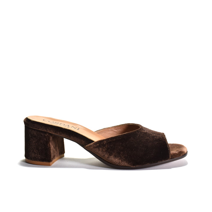 A single dark brown velvet mule sandal with a block heel, shown from a side profile view against a plain white background.