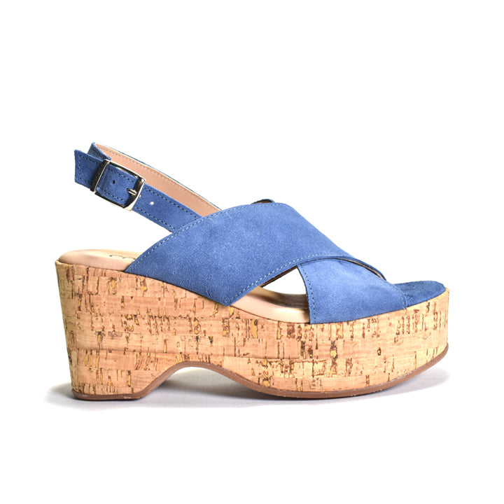 Blue sandal with cork wedge sole on a white background