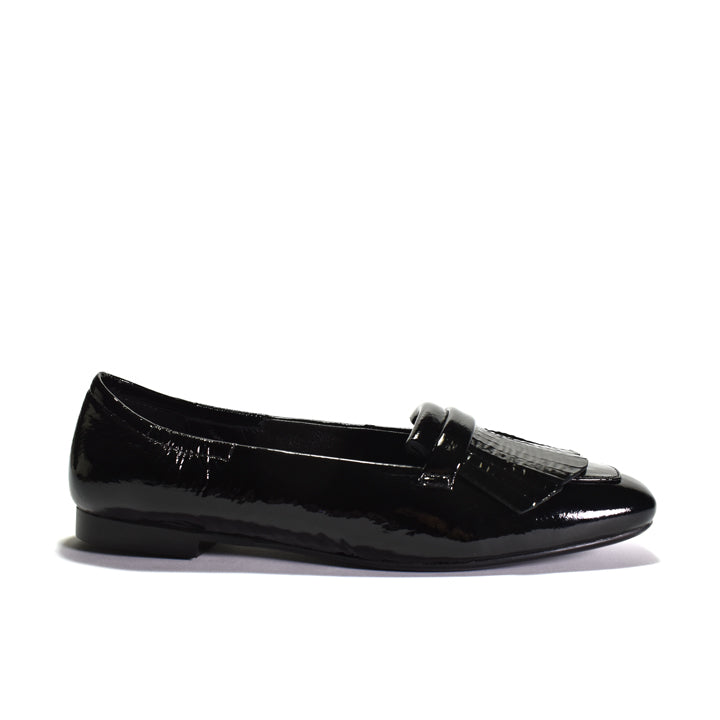 Black leather flat shoe on a light gray background