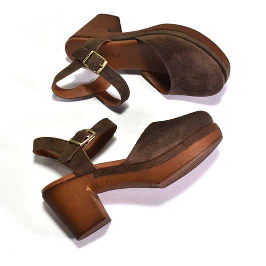 Pair of brown suede sandals with gold buckles on a white background