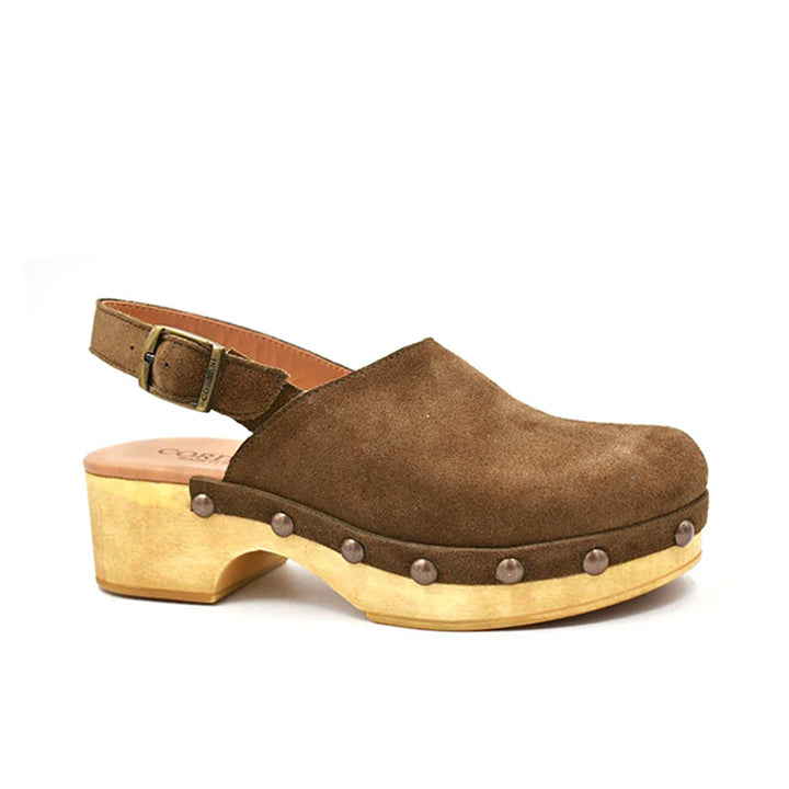 brown suede clog with a matching adjustable backstrap buckle and stud detail on a wood-like platform.