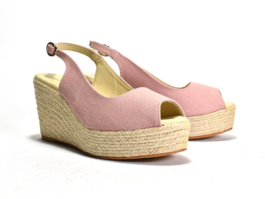 Pink wedge sandals with jute sole on a white background