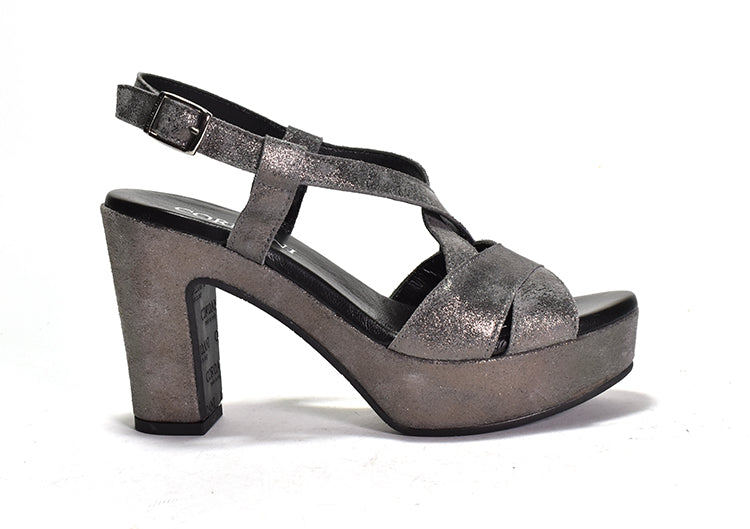 A dark silver platform sandal with criss-crossing straps, an adjustable metal buckle, and a chunky heel.