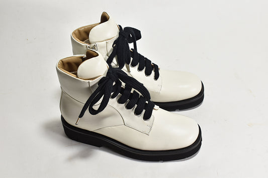 pair of white lace up boots