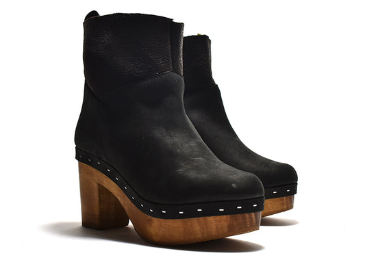 pair of black ankle bootie with a faux fur lining, suede upper, a light-weight wooden heel