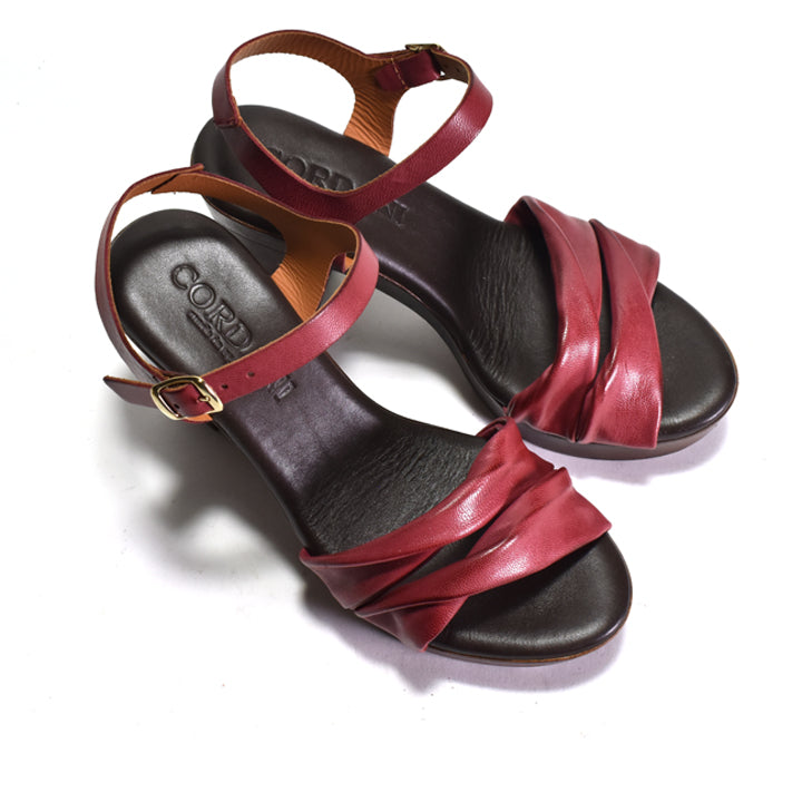 Pair of sandals with red straps on a white background
