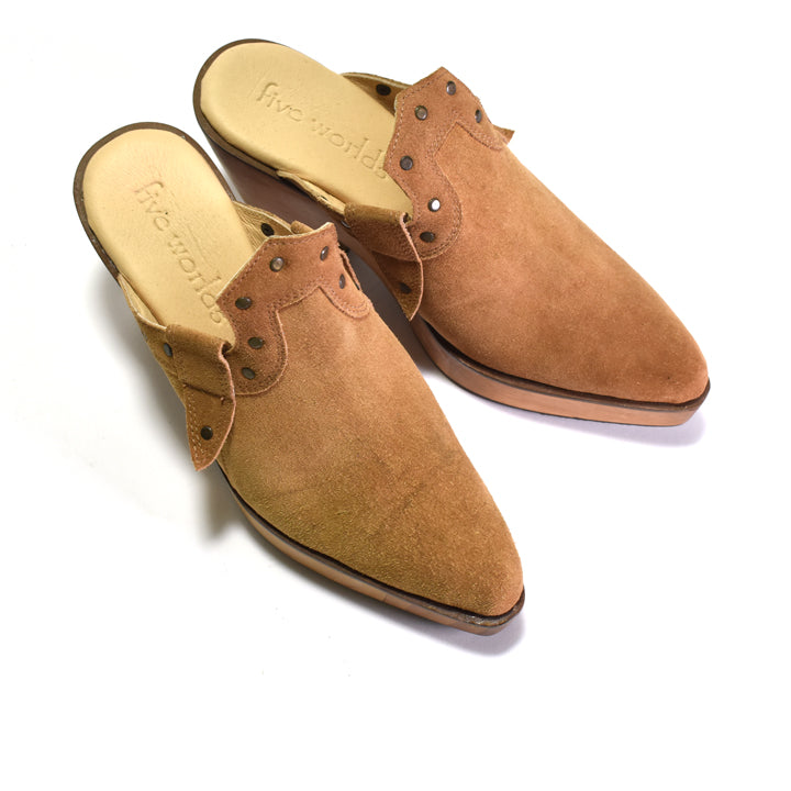 A pair of tan suede mule slip-on shoes with metal eyelets and a tan insole, photographed on a white background.