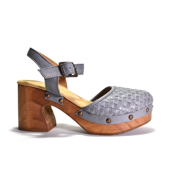 A single women's clog sandal with a woven gray upper, gray ankle strap with a buckle, and a brown wooden platform and block heel, shown on a white background.