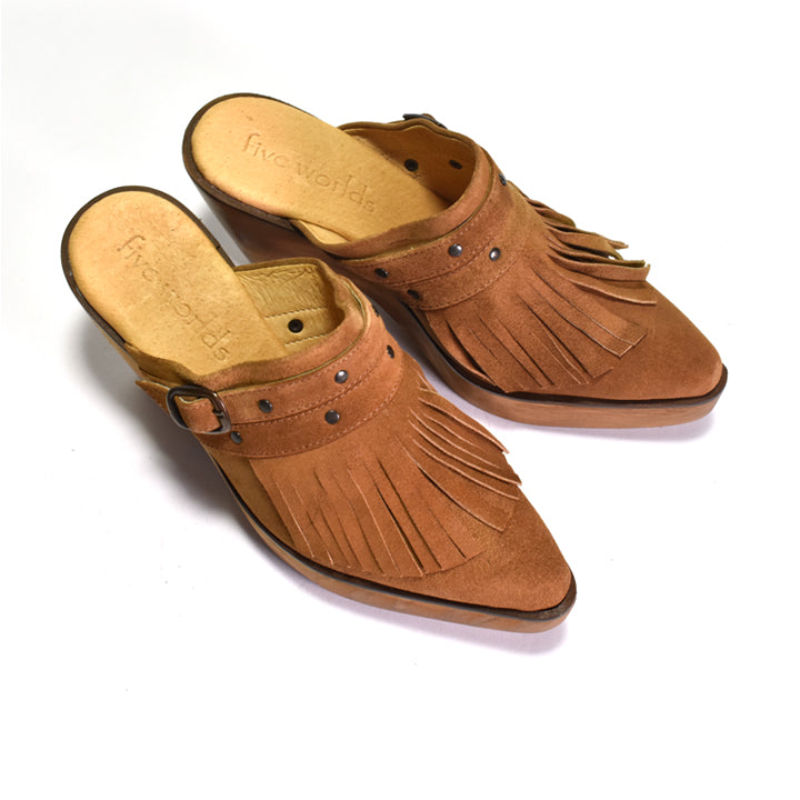 Pair of brown suede mules with fringe on a white background