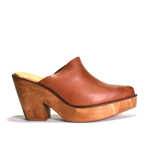Brown leather clog shoe with wooden sole on a white background