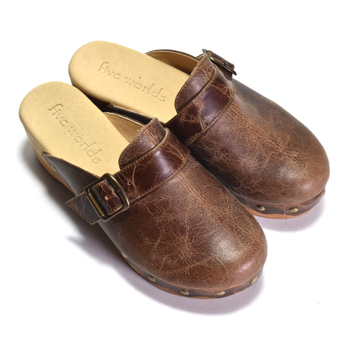 Pair of brown leather clogs with 'five worlds' branding on a white background