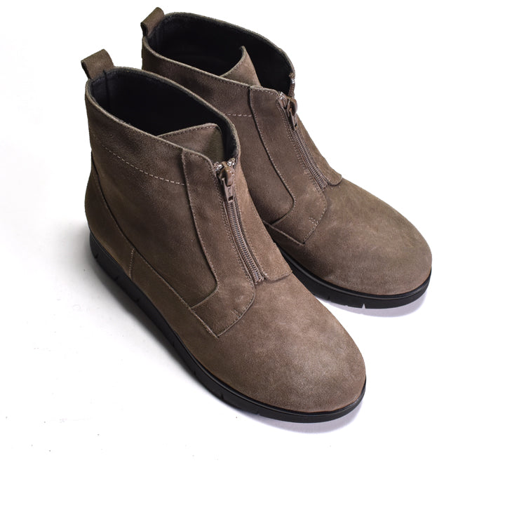 Pair of brown suede ankle boots with zippers on a white background