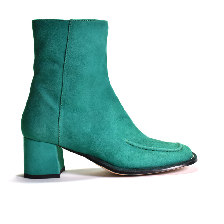 A single teal green suede ankle boot with a block heel and square toe, shown in profile against a white background.