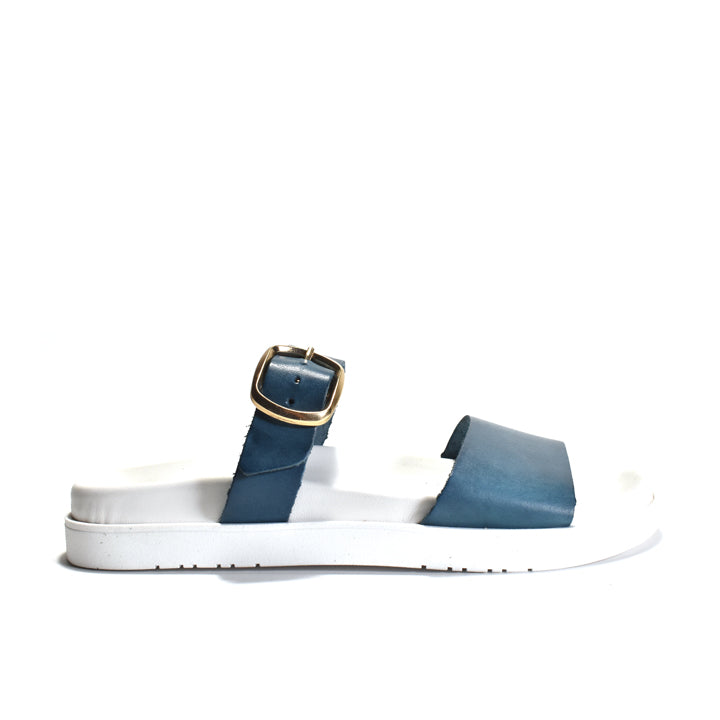 Blue and white sandal with a gold buckle on a white background