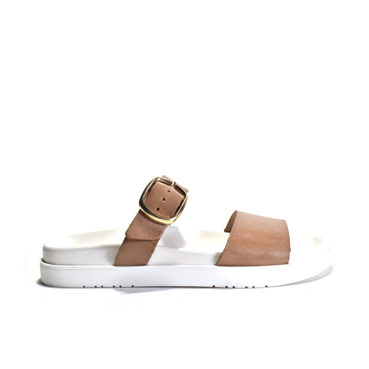 White sandal with brown strap and buckle on a white background