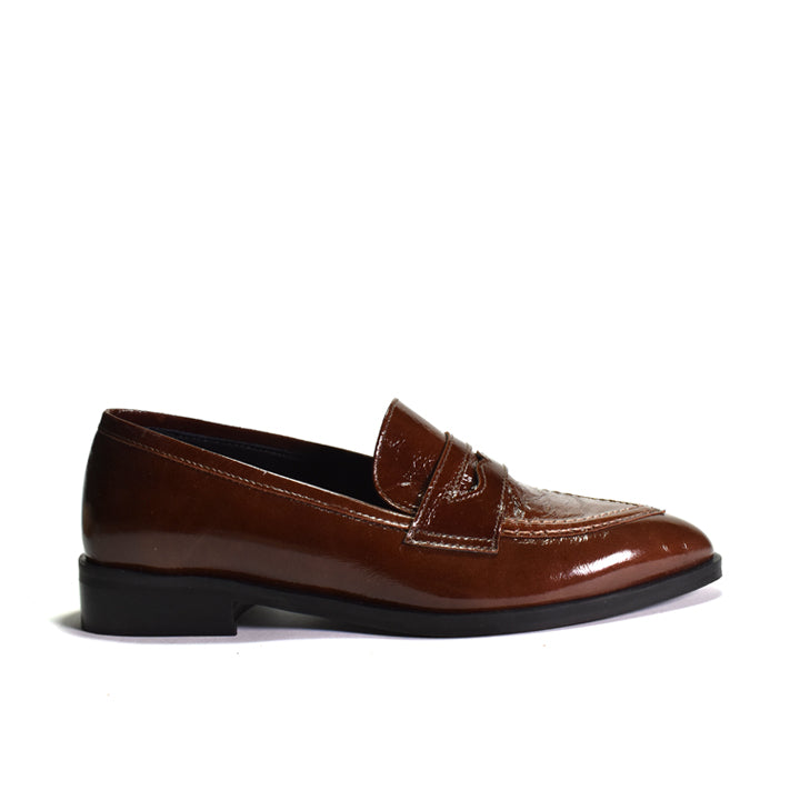 A single brown patent leather penny loafer with a pointed toe and black sole, shown in profile against a white background.