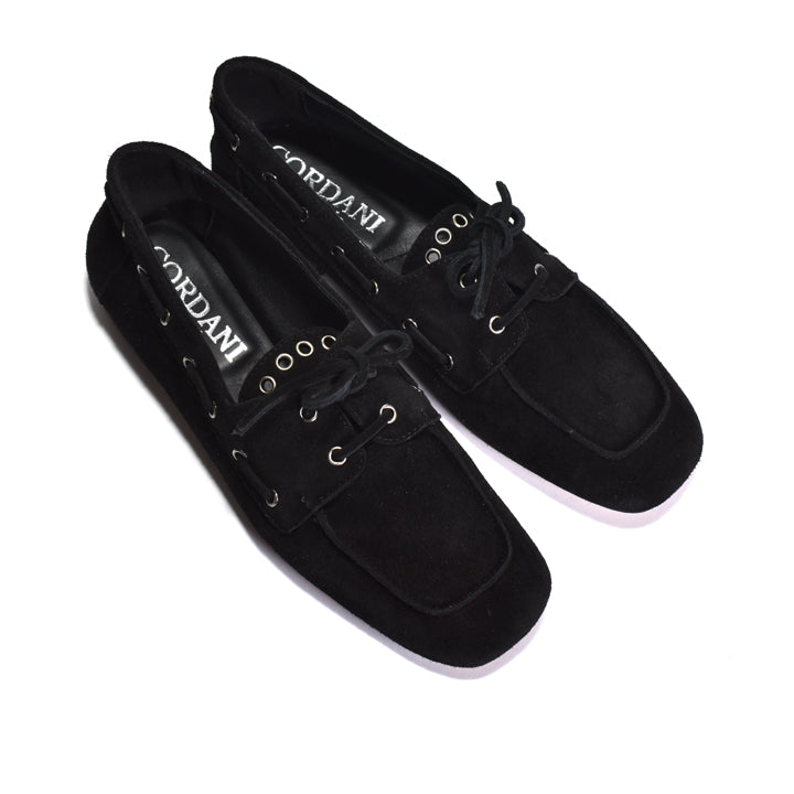 A pair of black suede boat-style loafers by Cordani, featuring black laces, metal eyelets, and a white sole, shown on a plain white background.