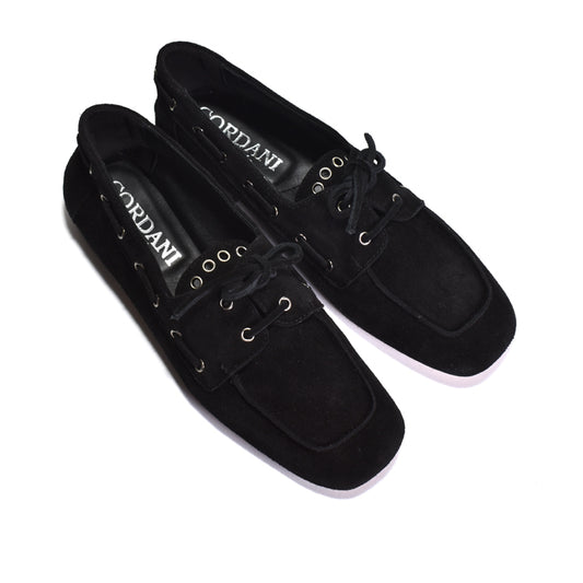 A pair of black suede boat-style loafers by Cordani, featuring black laces, metal eyelets, and a white sole, shown on a plain white background.