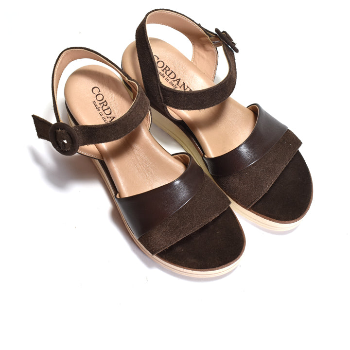 Brown sandals with suede straps on a white background