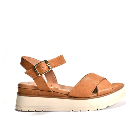Tan sandal with a white sole on a white background