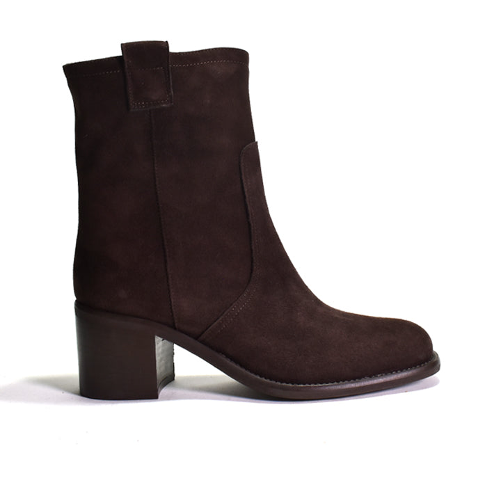 A dark brown suede ankle boot with a block heel, side slip pocket, and pull tab, shown from a side profile on a white background.
