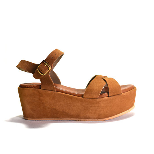 Brown suede wedge sandal with a strap on a white background