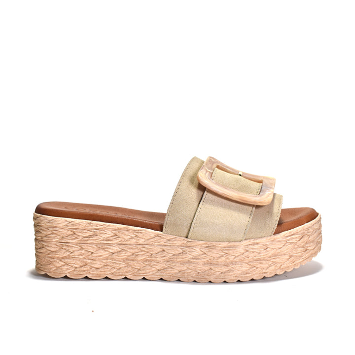 Beige sandal with woven sole on a white background