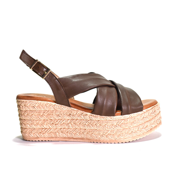 Brown sandal with woven wedge sole on a white background