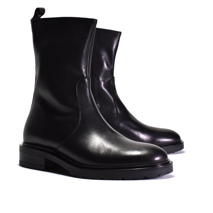 A pair of black leather Chelsea-style ankle boots with elastic side panels and low block heels, photographed on a clean white background.