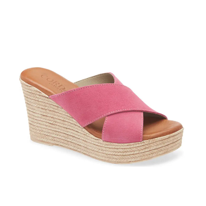 Pink wedge sandal with espadrille sole on a white background