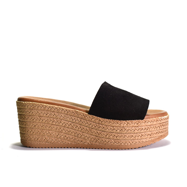 Black sandal with woven look platform sole on a white background