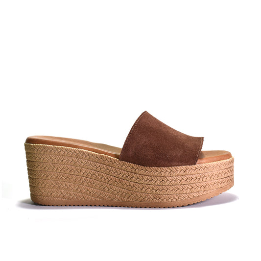 Brown wedge sandal with woven look sole on a white background