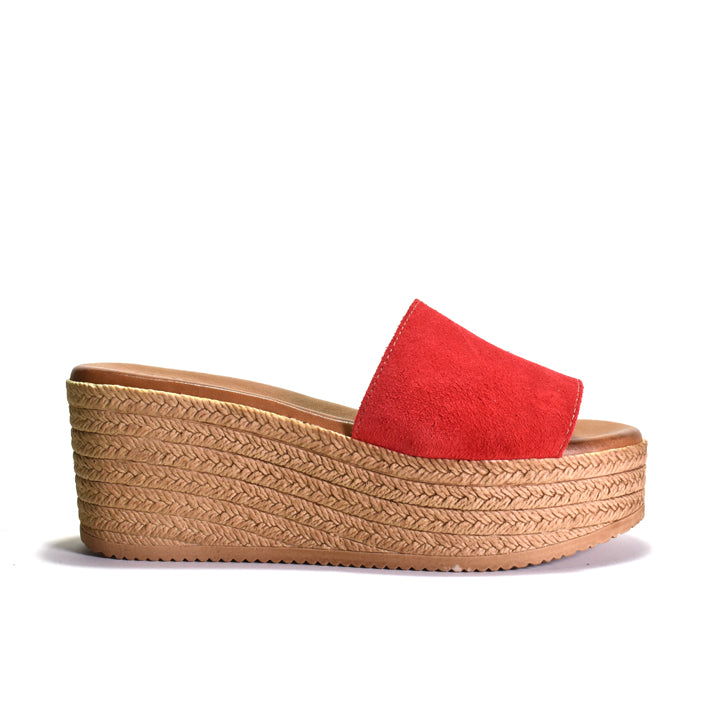 Red sandal with a woven look platform sole on a white background