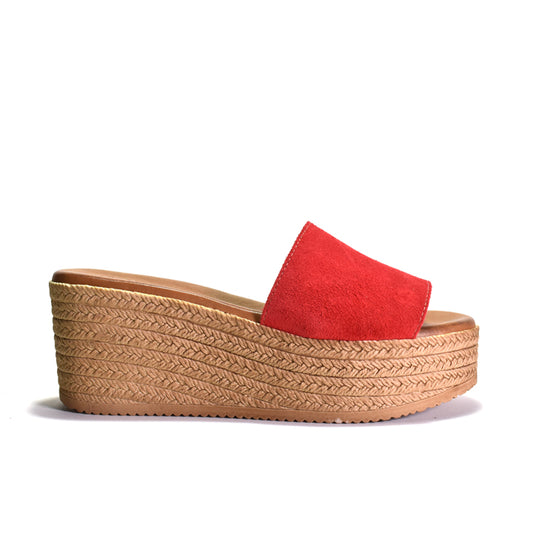 Red sandal with a woven look platform sole on a white background