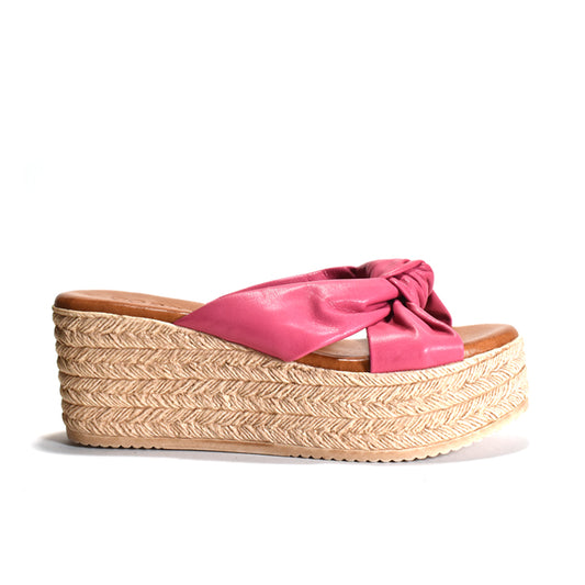 A single women's platform wedge sandal with a jute-look heel and toe strap, featuring a bright pink leather upper with a knotted detail, shown against a plain white background.