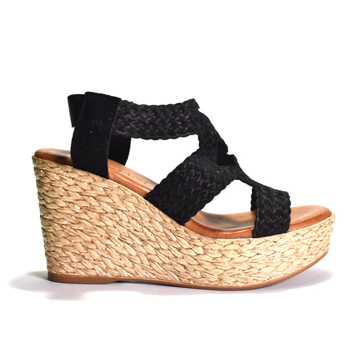 Black wedge sandal with woven sole on a white background