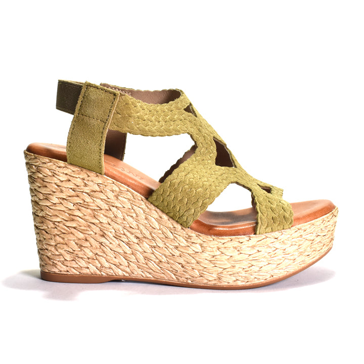 Green wedge sandal with woven sole on a white background
