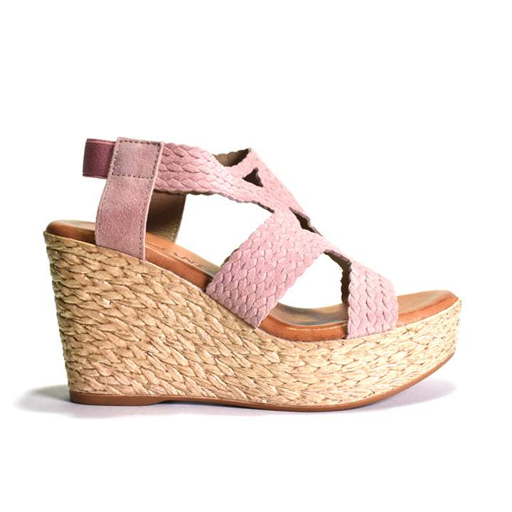 Pink wedge sandal with woven sole on a white background