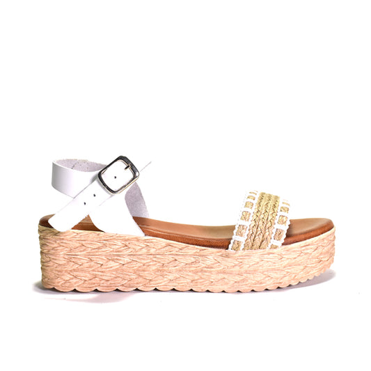 Woven sandal with a white strap and gold embellishments on a white background